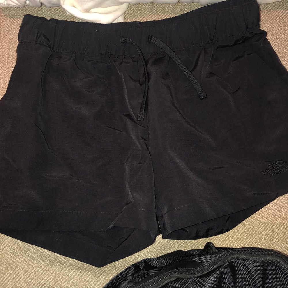 black north face running shorts